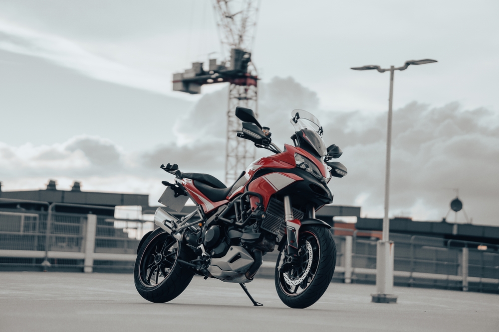 Red,Adventure,Style,Motorcycle,On,A,Roof,Top,Car,Park,