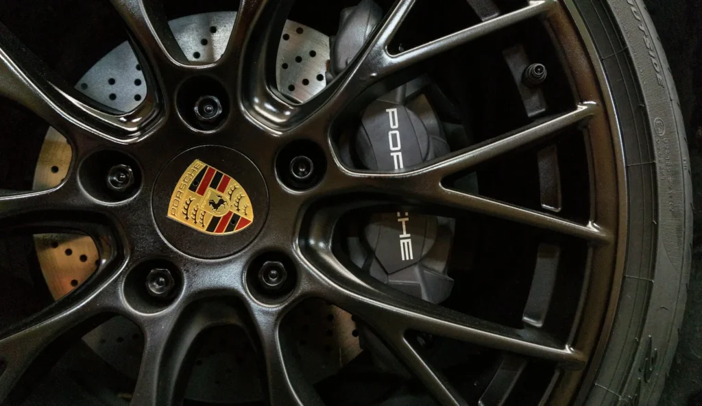 Drilled performance brake disc and Porsche caliper behind an alloy wheel