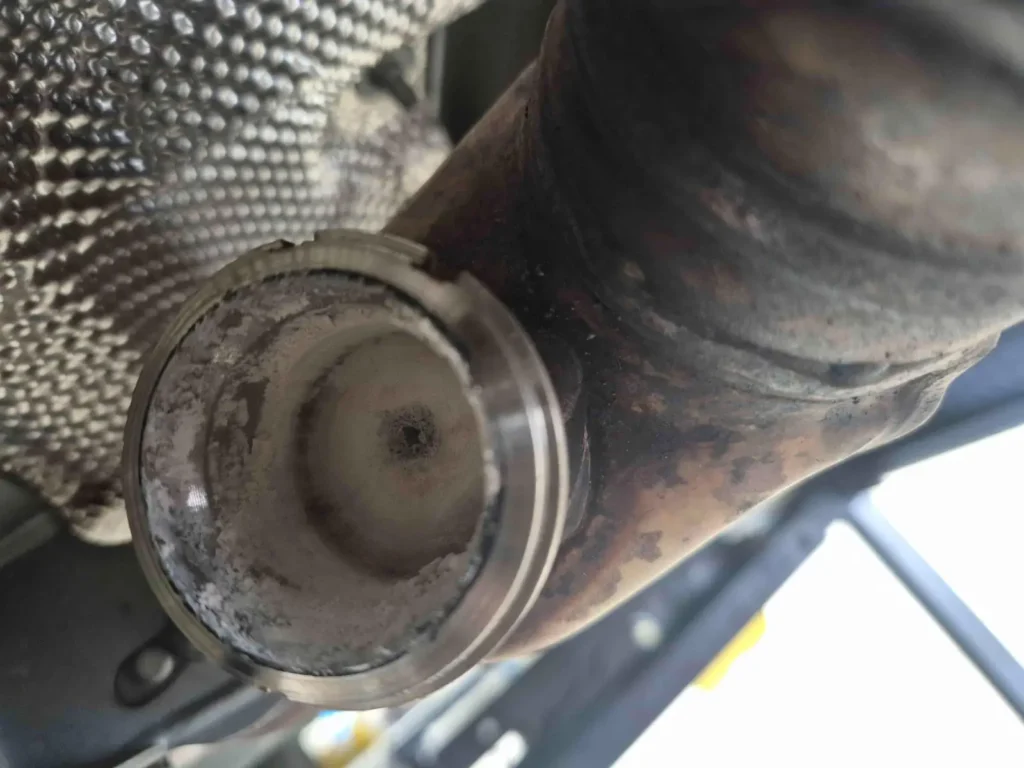 White urea crystal deposits inside the exhaust tip of a Mercedes GLC 220 d with a failed AdBlue system