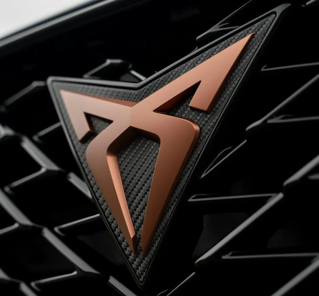 Copper Cupra badge on a carbon fibre grille of a Cupra Formentor