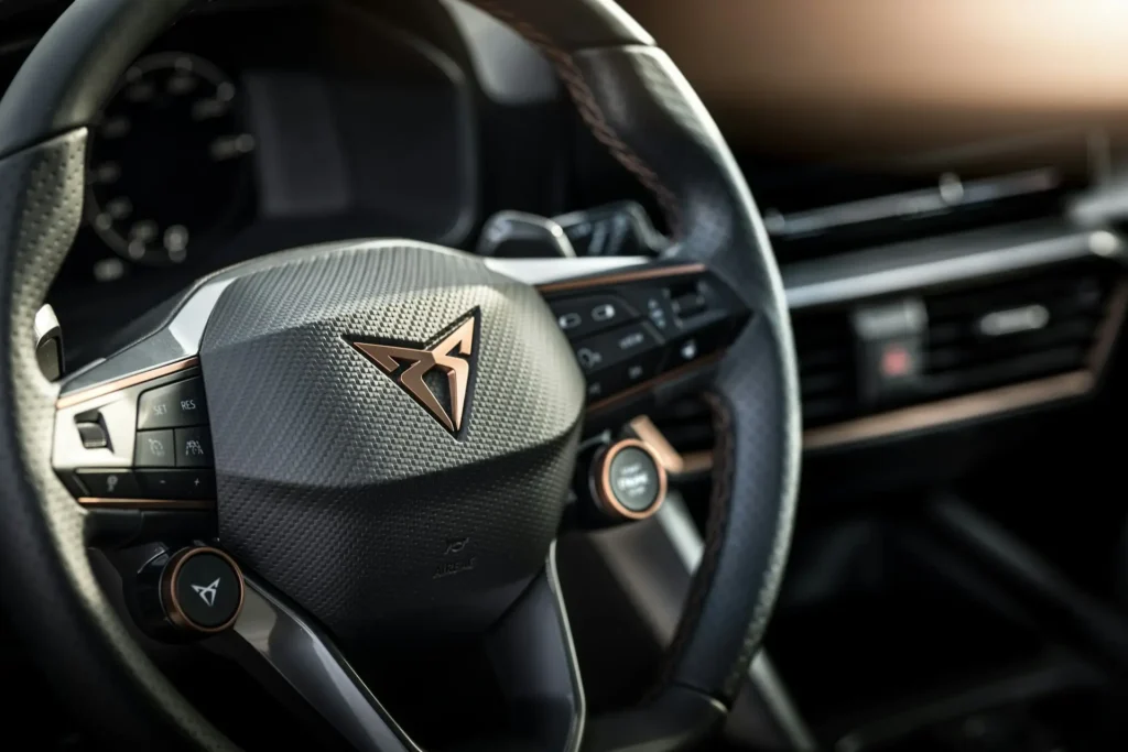 Cupra Leon steering wheel with copper Cupra mode button and paddle shifters