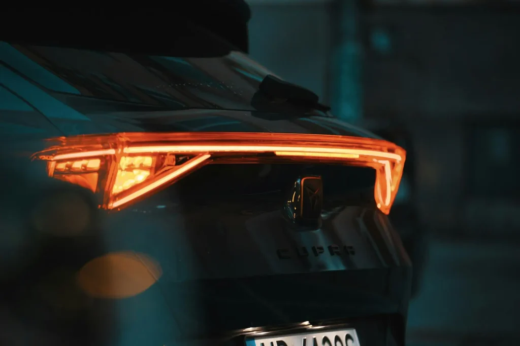 Rear LED light bar and Cupra lettering on the tailgate of a Cupra at night